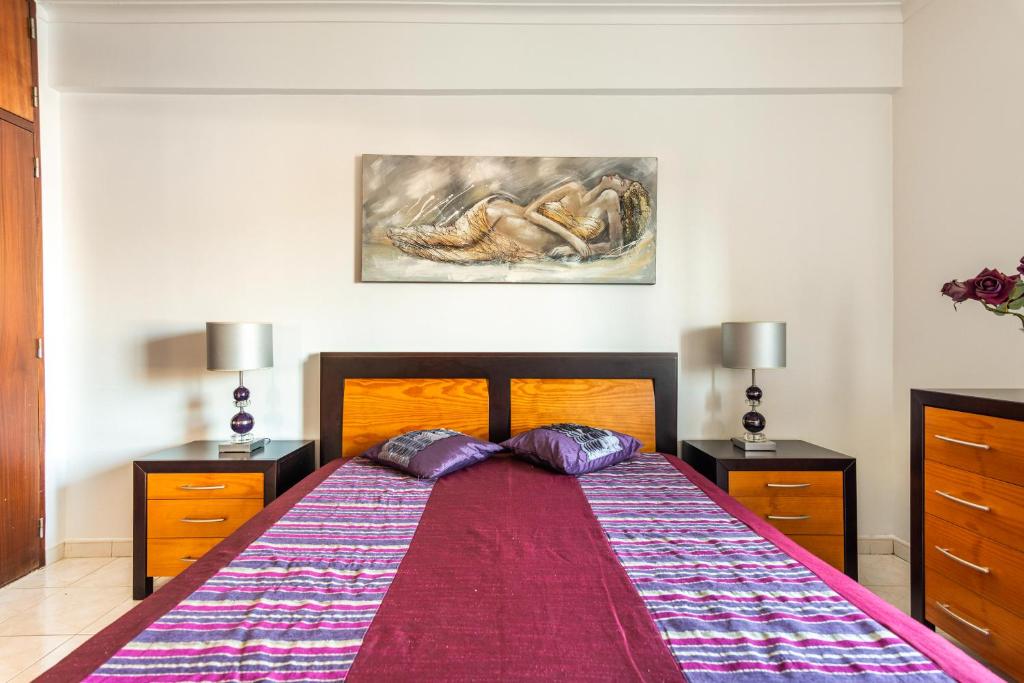 a bedroom with a large bed with two night stands at Isabel Dream III, 400m from the train in Rinchoa