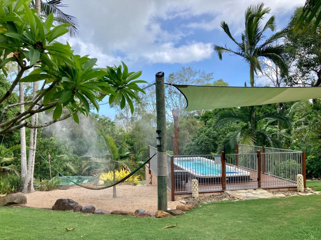a playground with a slide and a pool at Butterfly Studio in Proserpine