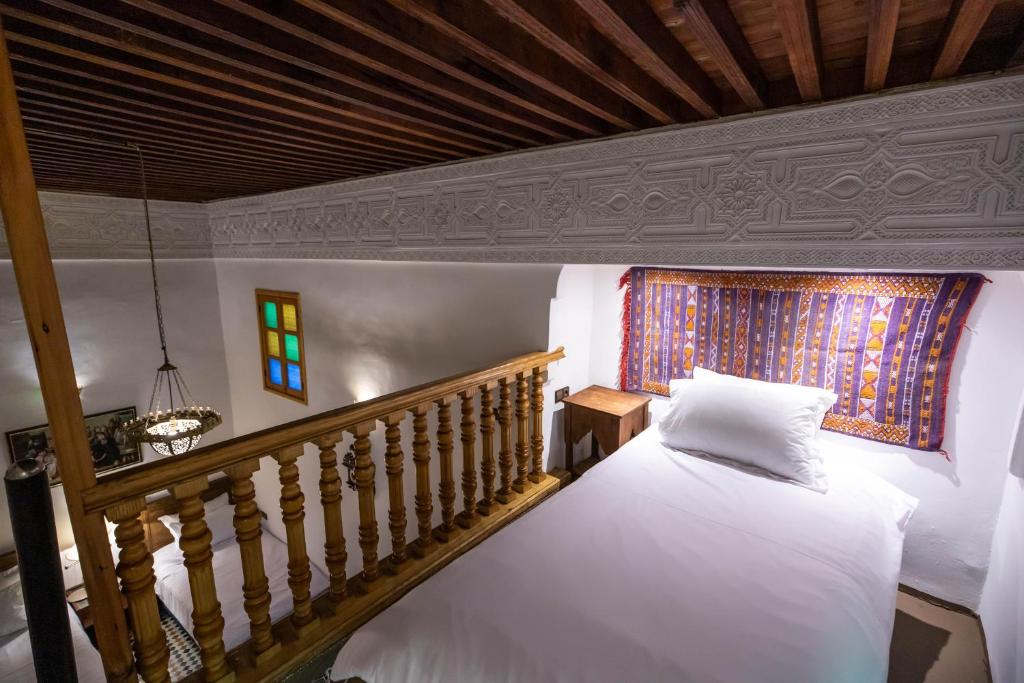 Un pat sau paturi într-o cameră la Riad Soultana