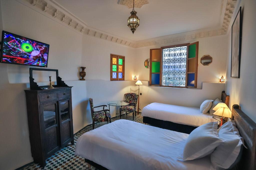 Un pat sau paturi într-o cameră la Riad Soultana