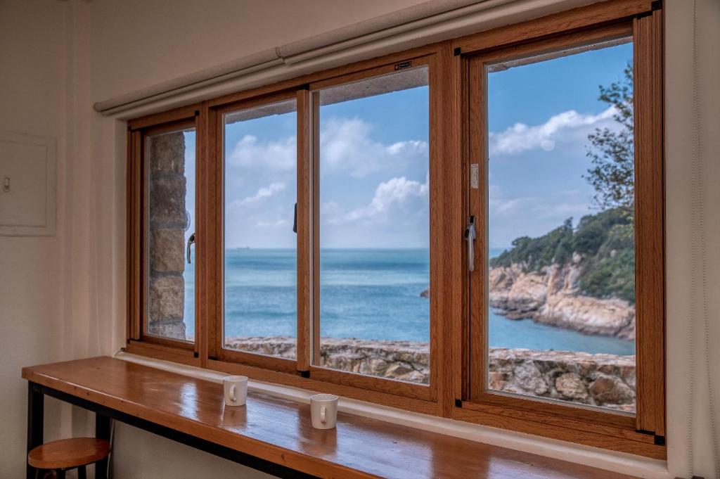 una finestra con vista sull'oceano di Mulight B&B a Nangan