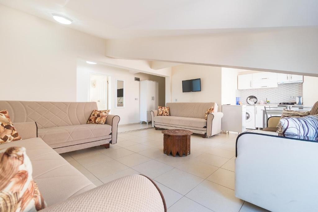 a living room with couches and a kitchen at Apartments Near to City Center and Beach in Marmaris
