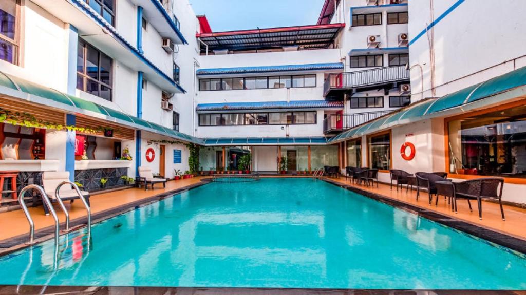 una piscina en medio de un edificio en La-Paz Gardens Beacon Hotel - Vasco da Gama Goa, en Vasco Da Gama