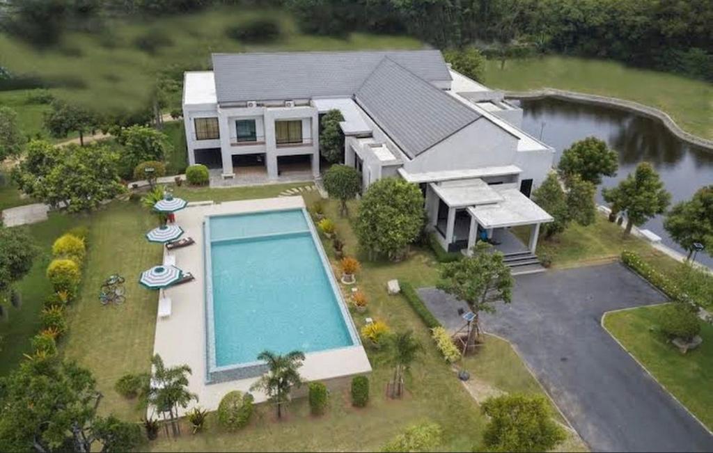 an aerial view of a house with a swimming pool at Pirom Garden Private Villa in Pattaya North