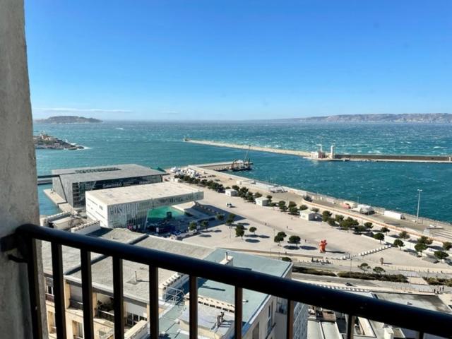 a view of the ocean from a balcony of a building at Vue Mer Le Panoramique Vieux-Port de Marseille in Marseille
