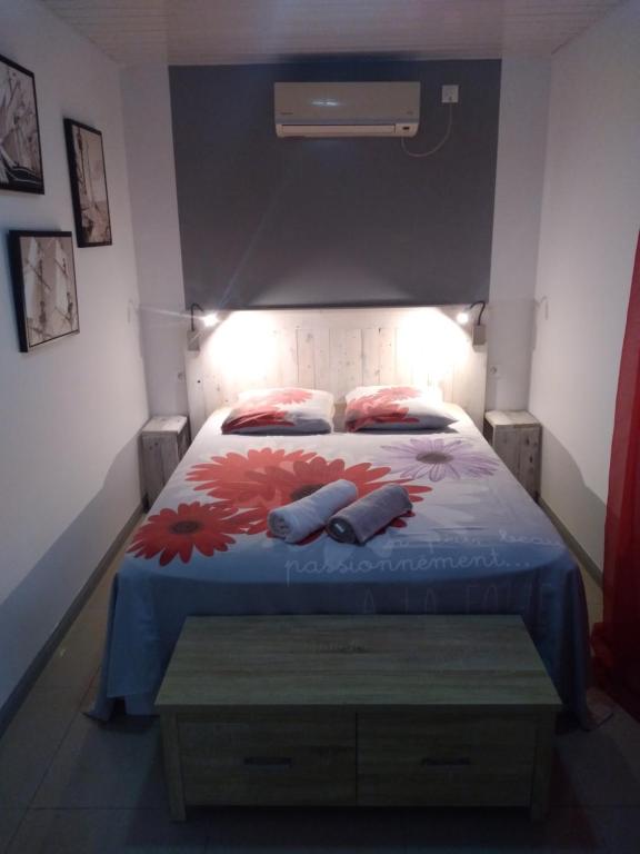 a bedroom with a bed with two pillows on it at Chez Pascal et Claudia in Kumak