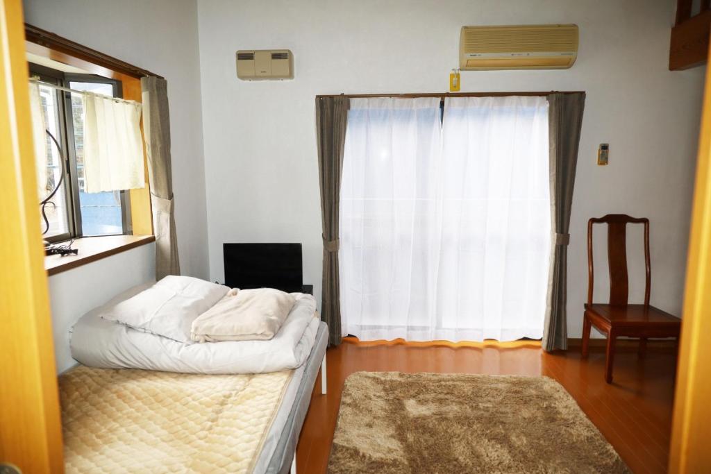 a small room with a bed and a window at Crane / Vacation STAY 564 in Kunisaki