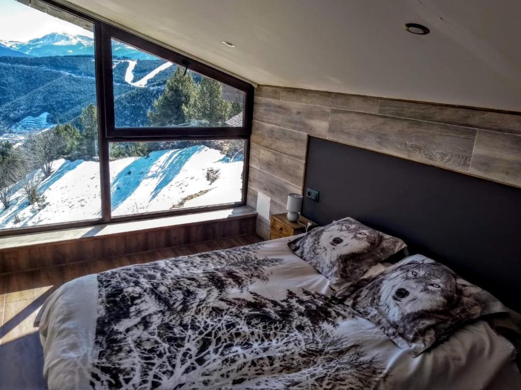 a bedroom with a bed and a large window at Magic Borda Cremat HUT4-5018 in La Massana