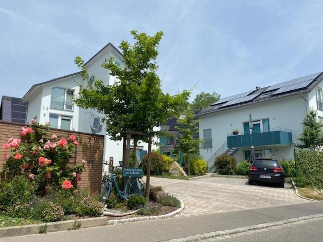 a house with a car parked in a driveway at EntdeckerFERIEN am Bodensee in Friedrichshafen