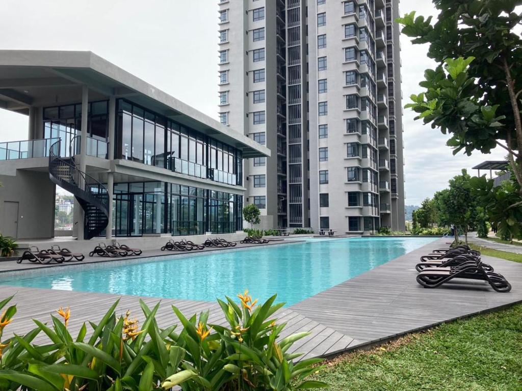 a large building with a swimming pool in front of a building at Astoria Ampang By Grabstay in Kuala Lumpur