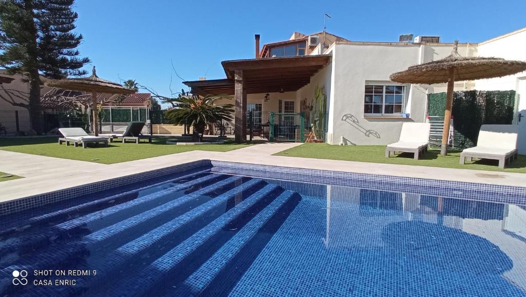 una piscina frente a una casa en Casa de sueños Benasha, en Deltebre