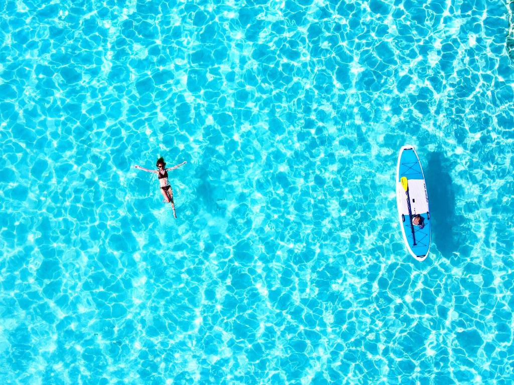 two people on surfboards in a pool of water at Hotel Santa Barbara Miyakojima Resort in Miyako-jima