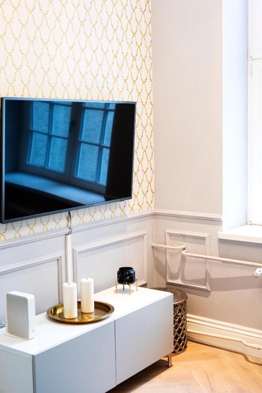 a living room with a tv on a wall at Maya's Flats & Resorts 44 - 3 rooms apartment on Chlebnicka Street Gdańsk Old Town in Gdańsk