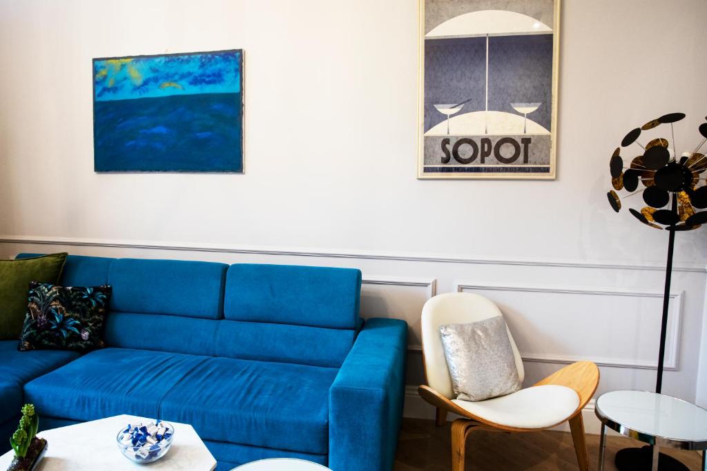 a living room with a blue couch and chairs at Maya's Flats & Resorts 44 - 3 rooms apartment on Chlebnicka Street Gdańsk Old Town in Gdańsk