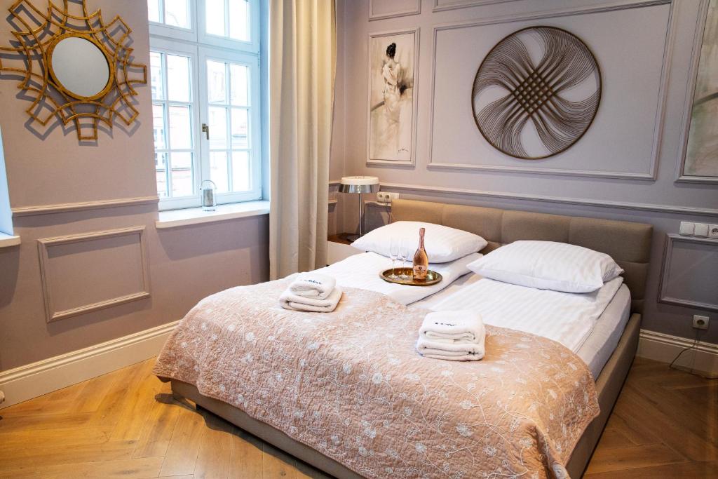 a bedroom with a bed with two towels on it at Maya's Flats & Resorts 44 - 3 rooms apartment on Chlebnicka Street Gdańsk Old Town in Gdańsk