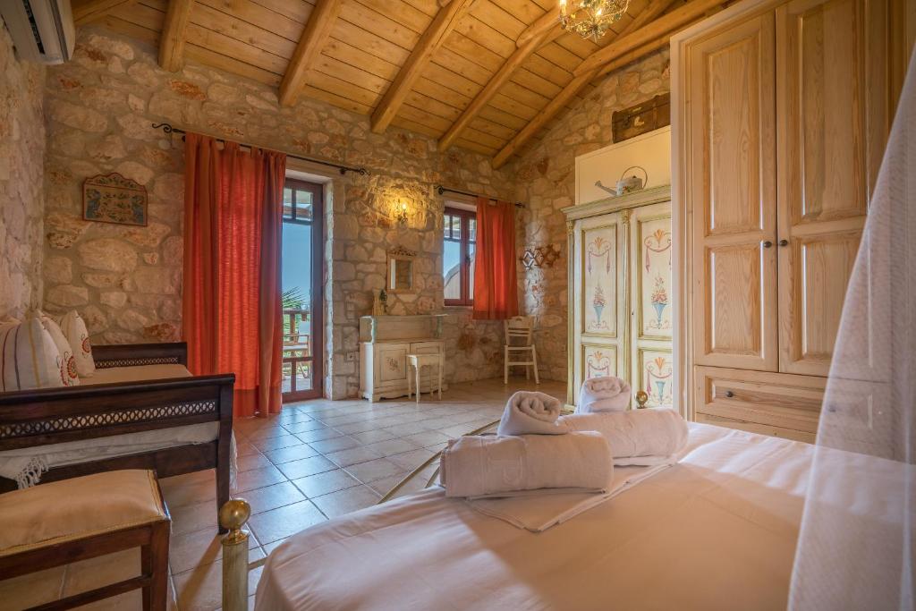 a bedroom with a bed and a piano in a room at Myrties stone houses - Ta Petrina in Vasilikos