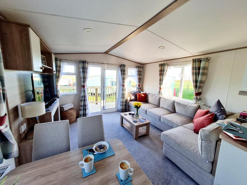 a living room with a couch and a table at Robin Hood's Retreat in Robin Hood's Bay