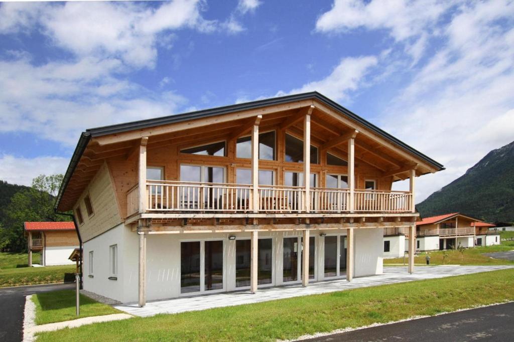 a house with a balcony on the side of it at Apartment with sauna and panoramic view in Inzell in Inzell