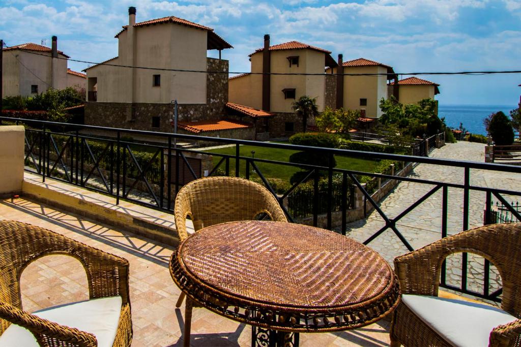 a group of chairs and a table on a balcony at Possidi Villas by Halkidiki Villas in Possidi