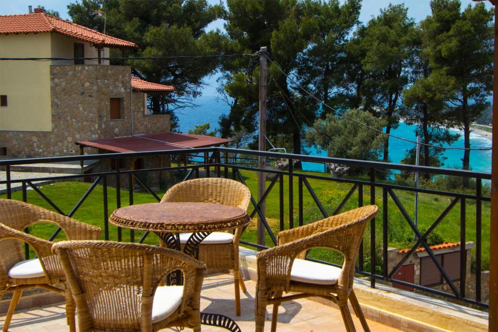 a table and chairs on a balcony with a view at Possidi Villas by Halkidiki Villas in Possidi