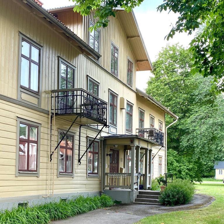 a yellow building with stairs and balconies on it at Mössebergs vandrarhem in Falköping