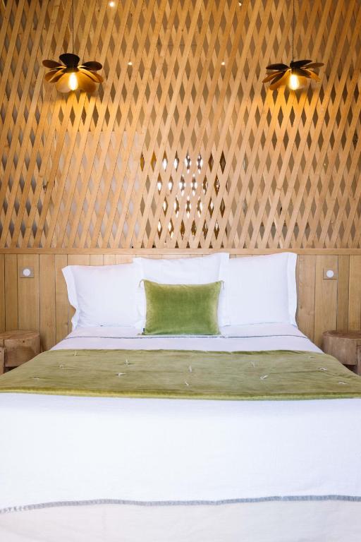 a bedroom with a large white bed with wooden walls at La Course in Bordeaux