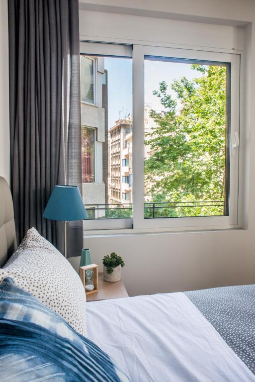 A bed or beds in a room at A23 Premium suite with balcony near Parthenon