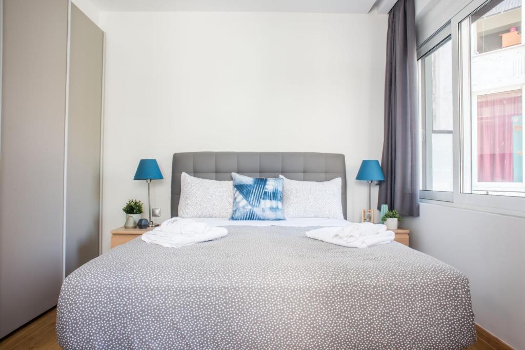 A bed or beds in a room at A23 Premium suite with balcony near Parthenon
