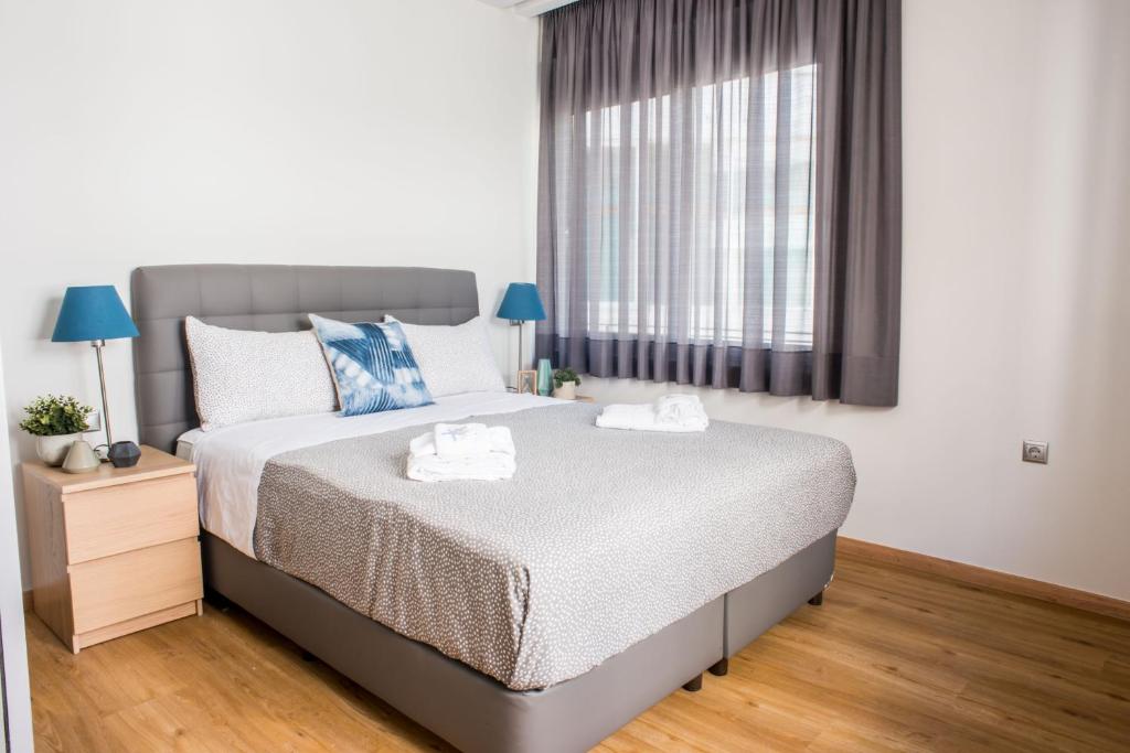 A bed or beds in a room at A23 Premium suite with balcony near Parthenon