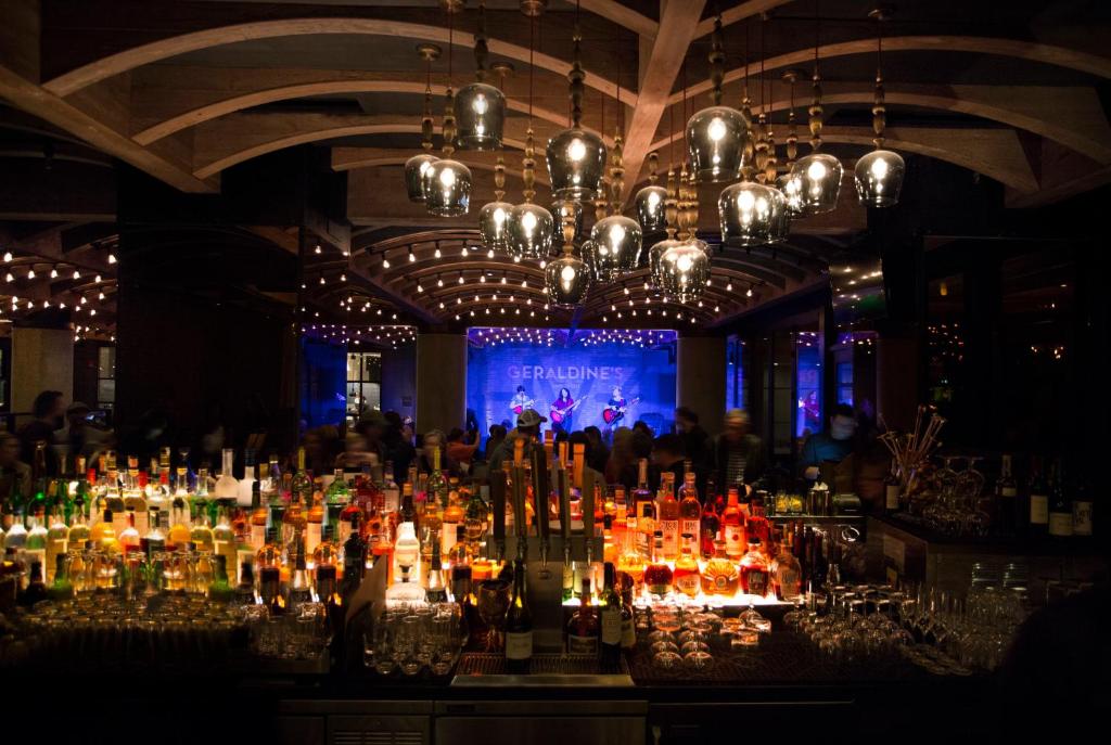 a bar with a lot of bottles of wine at Hotel Van Zandt in Austin