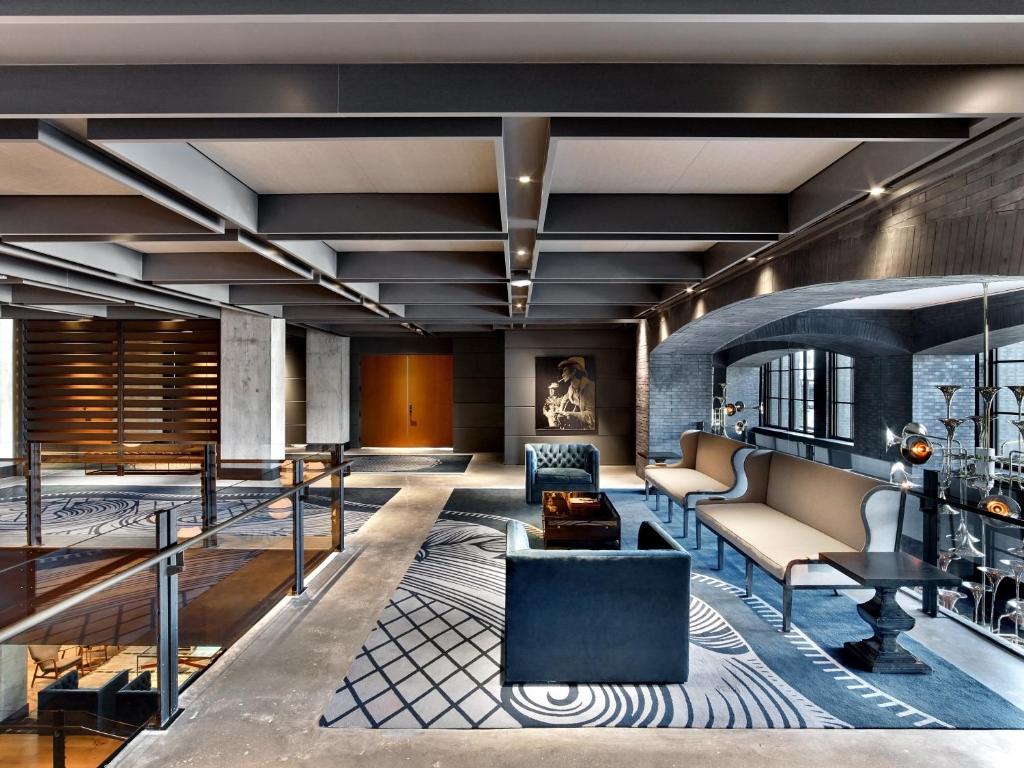 a lobby with chairs and a couch and a table at Hotel Van Zandt in Austin