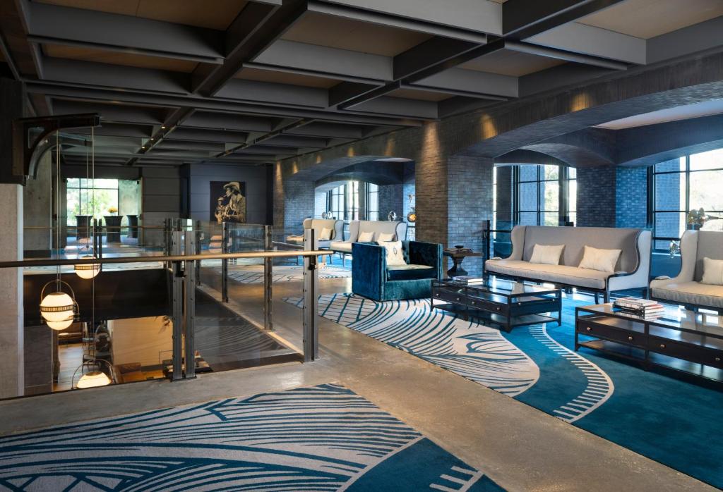 a lobby with couches and chairs and a table at Hotel Van Zandt in Austin