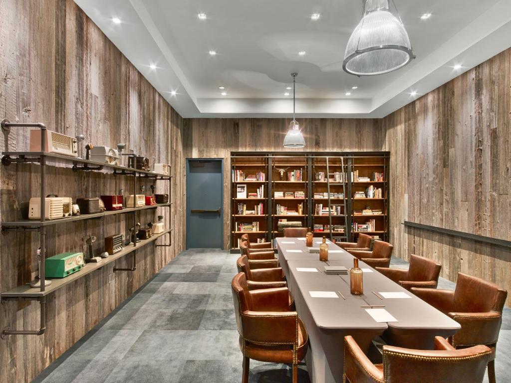 a dining room with a long table and chairs at Hotel Van Zandt in Austin