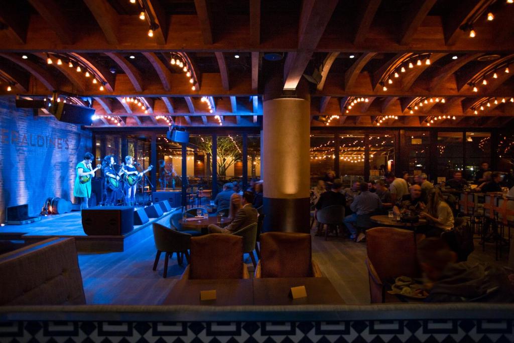 a room with a stage with people sitting at tables at Hotel Van Zandt in Austin