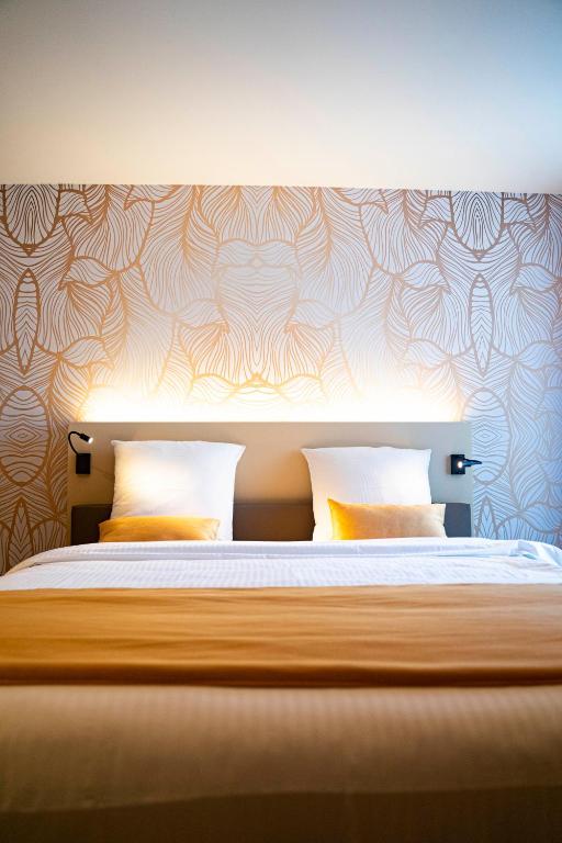 Postel nebo postele na pokoji v ubytování Hotel Amfora
