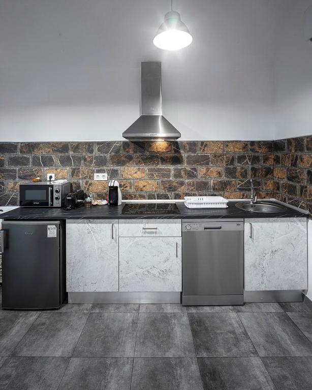 Kuchyň nebo kuchyňský kout v ubytování Apartamentos Gladiador