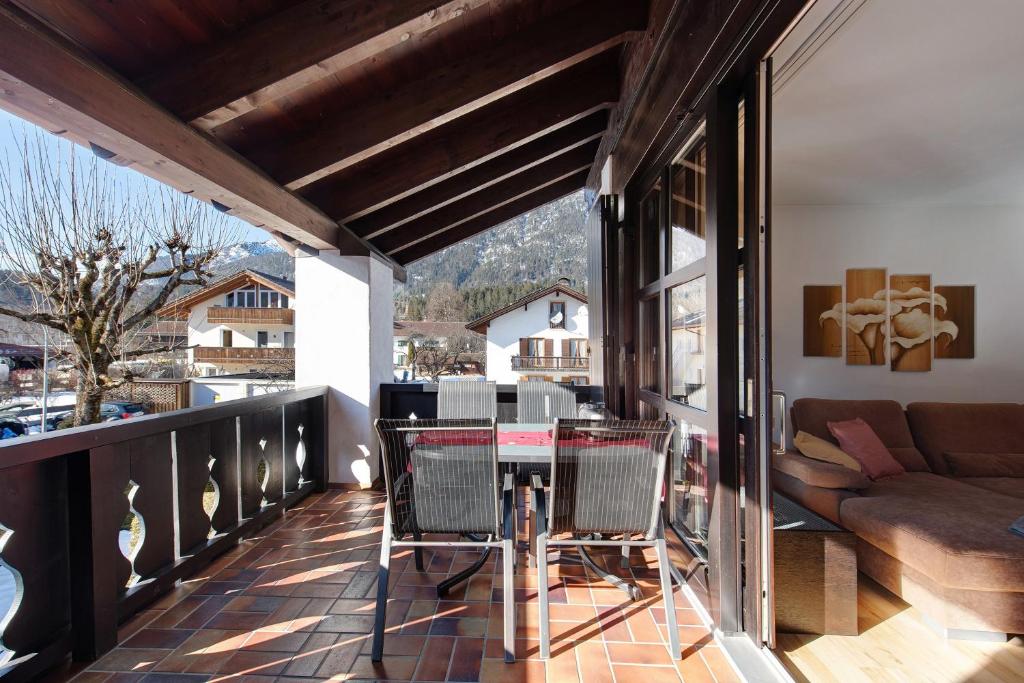 a balcony with a table and chairs and a couch at Fewo Christina in Garmisch-Partenkirchen
