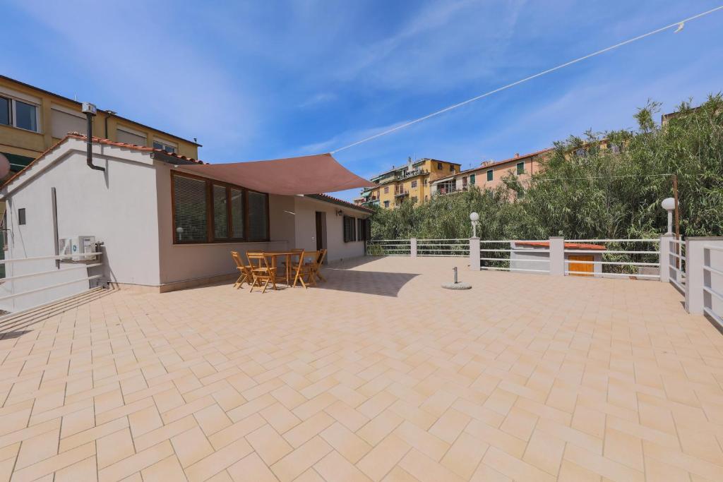 a patio with tables and chairs in a building at Appartamento La Terrazza in Portoferraio