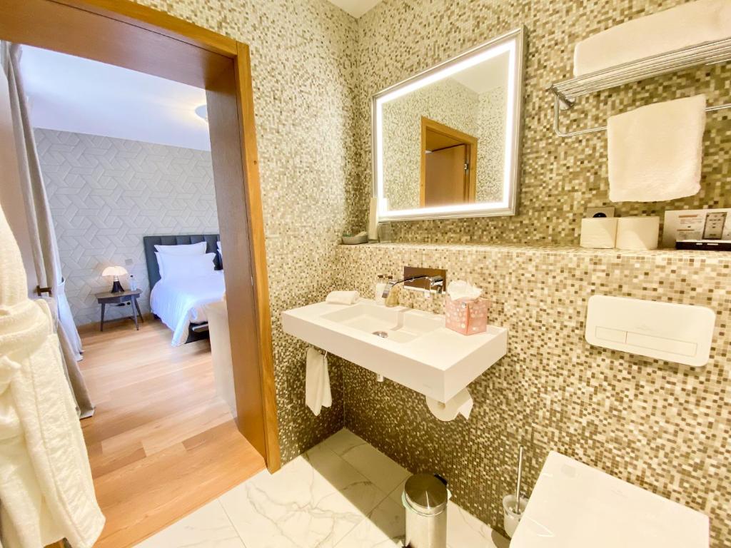 a bathroom with a sink and a mirror at Petit Monlot - Saint-Emilion in Saint-Émilion