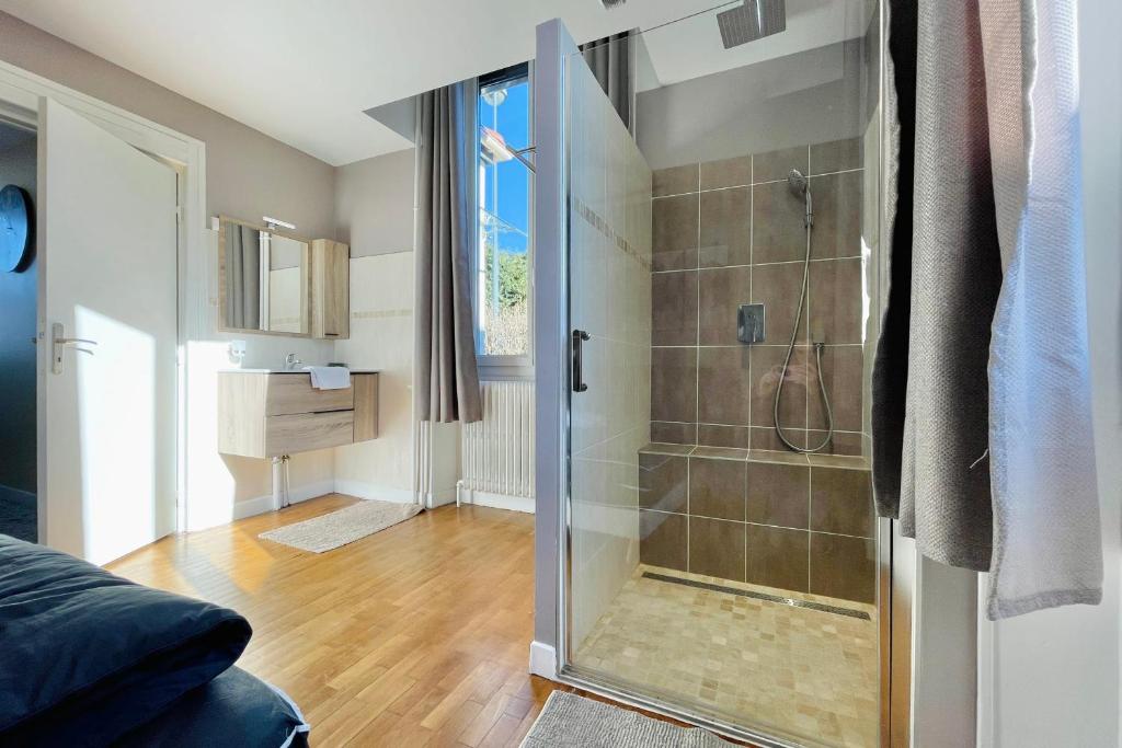 a bathroom with a shower with a glass door at The City in the Country #CB in Gières