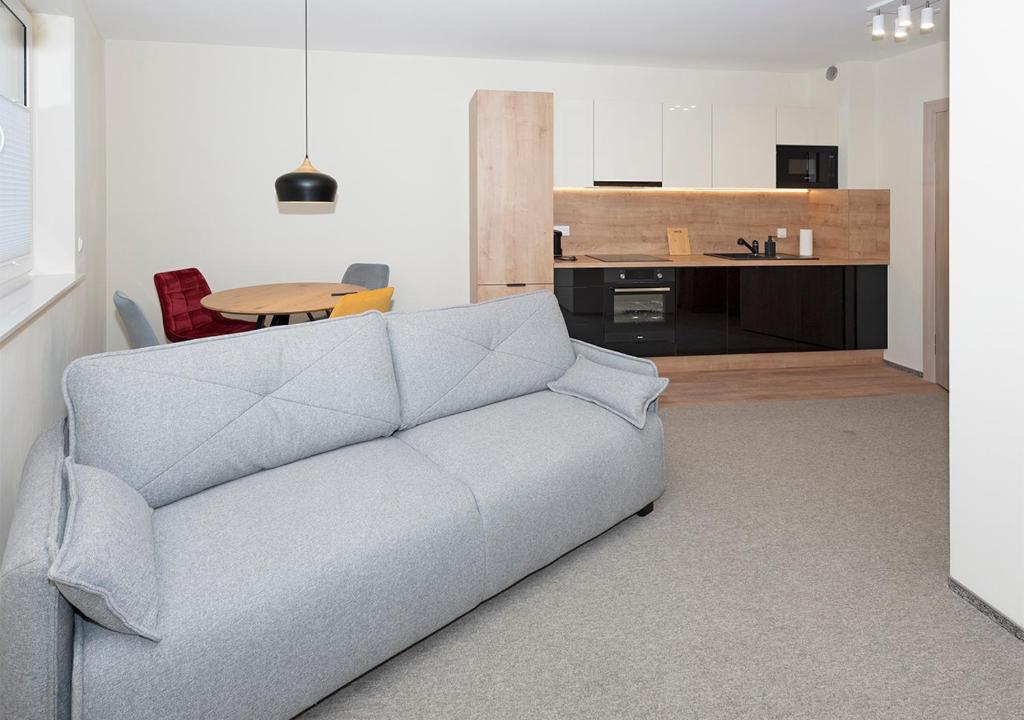 a living room with a couch and a table at Apartament Piano in Świeradów-Zdrój
