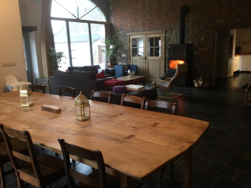 a large wooden table in a living room with a couch at Maison Druyard huis met 5 slaapkamers in Durbuy