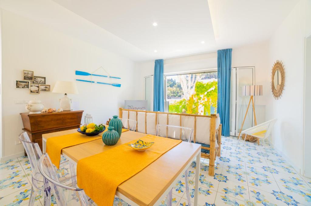 a dining room with a yellow table and chairs at TaoApartments - Casa Salina in Taormina