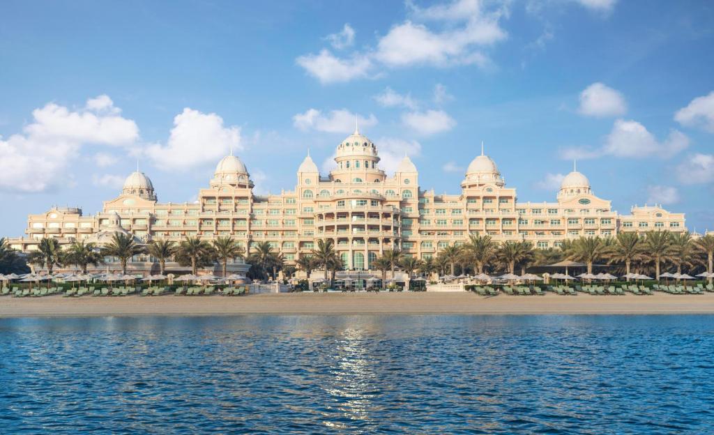a large body of water with a large building at Raffles The Palm in Dubai
