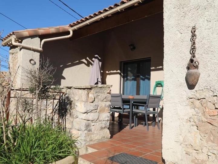 un patio de una casa con mesa y sillas en Sète, Villa Clara maison 5 étoiles avec piscine, en Sète