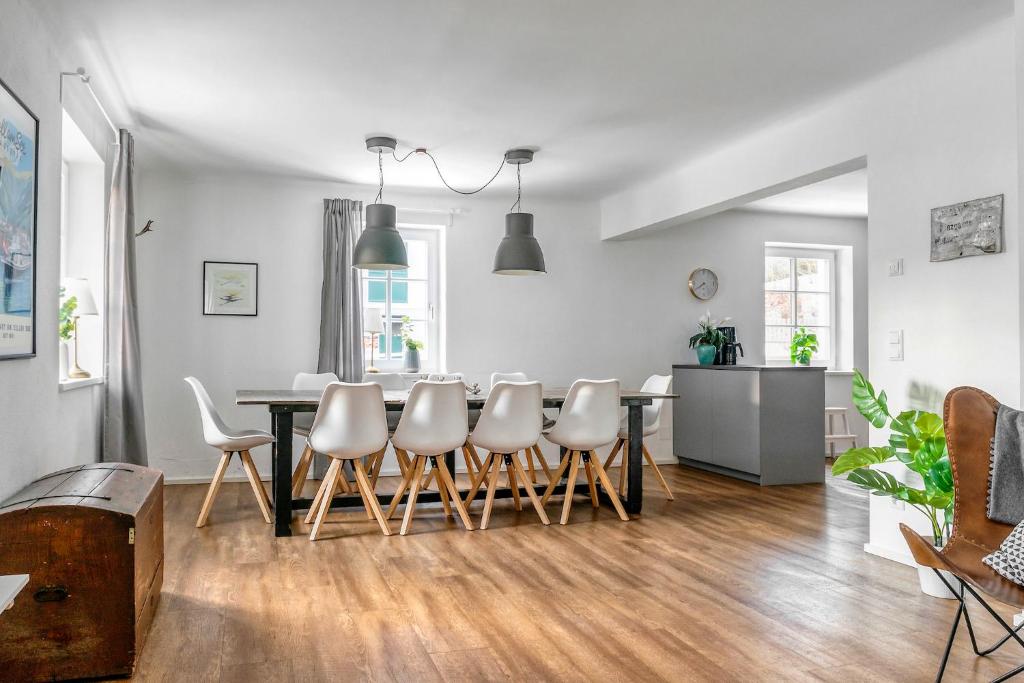 a kitchen and dining room with a table and chairs at Villa Alpenbach - by Alpen Apartments in Zell am See