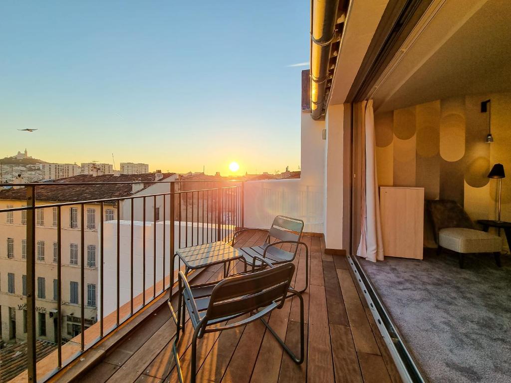 a balcony with a table and chairs on a balcony at Alex Hotel & Spa in Marseille