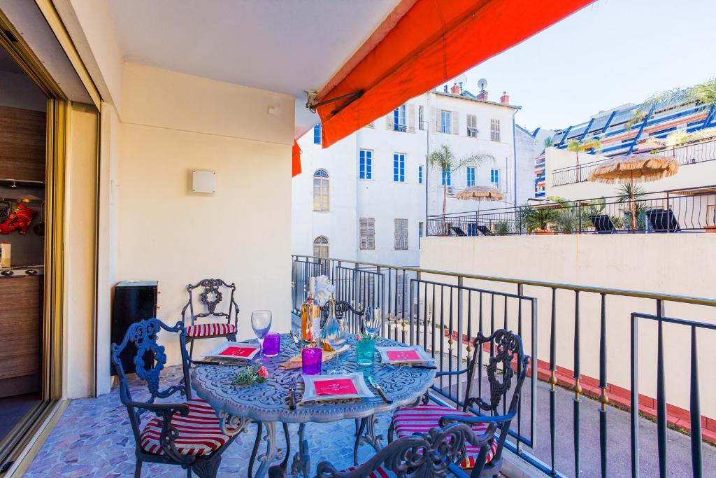 a balcony with a table and chairs on a balcony at Le Joffre Grimaldi Nice AP2089 in Nice
