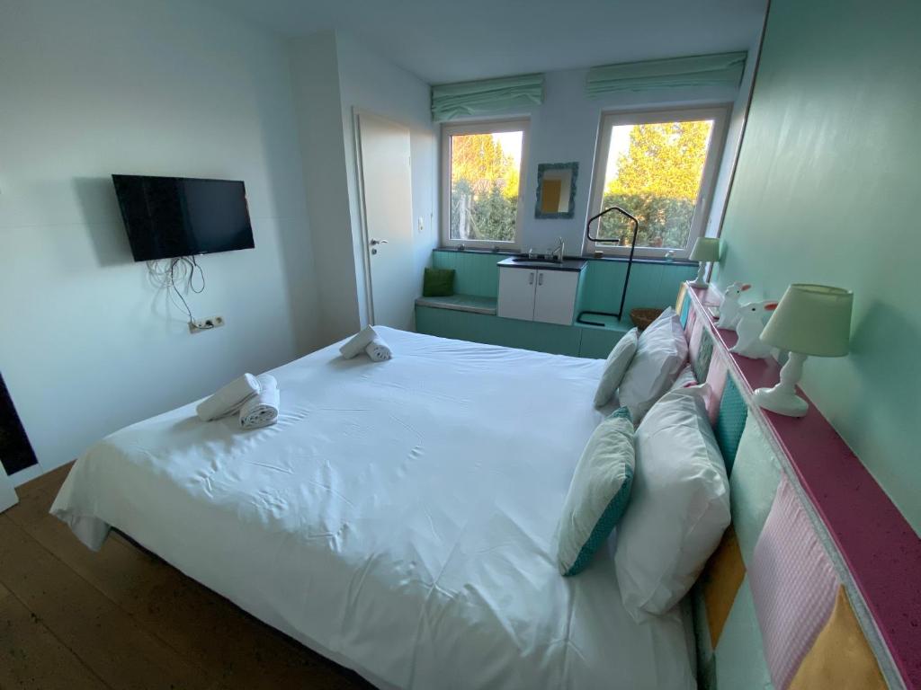 Un ou plusieurs lits dans un hébergement de l'établissement Maison Jules