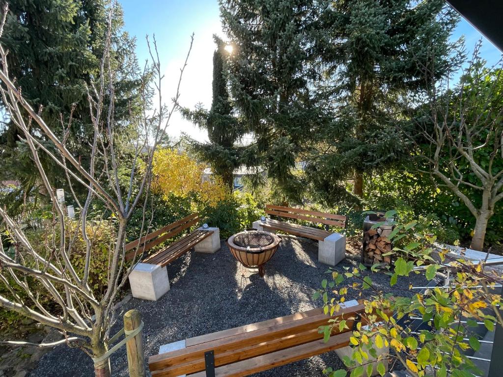 a group of benches in a garden with trees at Grüne Oase Am Mausauel in Nideggen